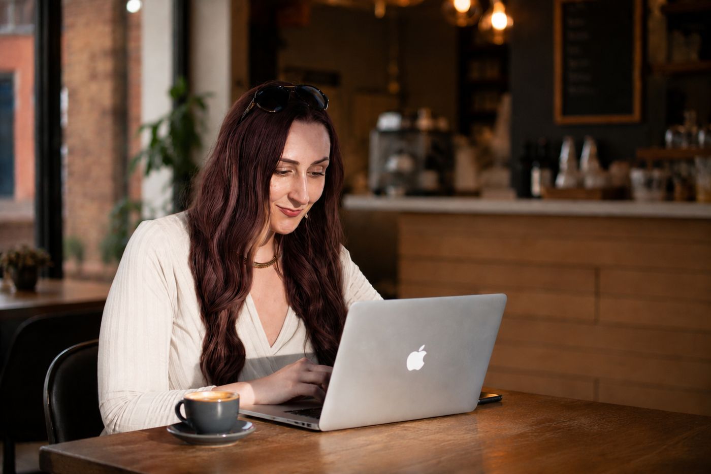 Katie Ford working on strategy in a cafe